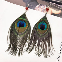 Close-up of stylish tassel earrings showcasing peacock feathers 1