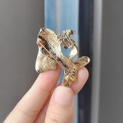 Close-up of sparkling animal brooch on clothing