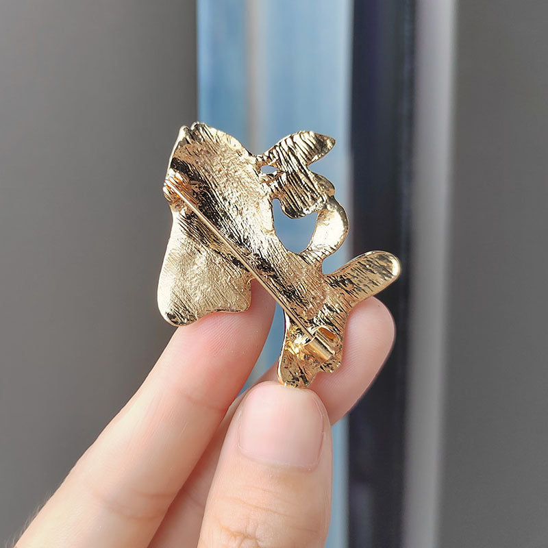Close-up of sparkling animal brooch on clothing