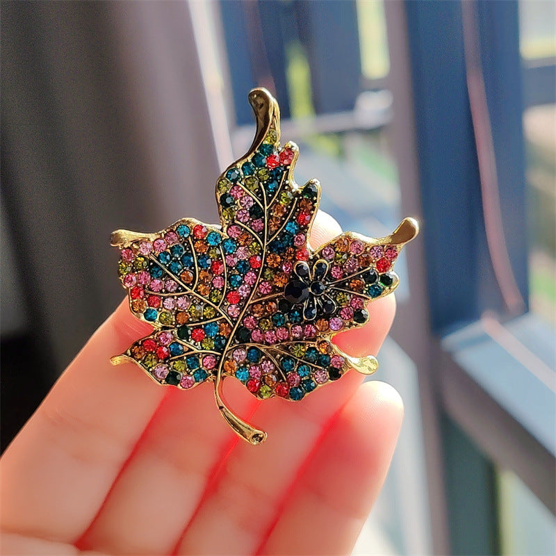 Close-up image of leaf-shaped rhinestone brooch