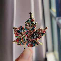 Close-up image of leaf-shaped rhinestone brooch