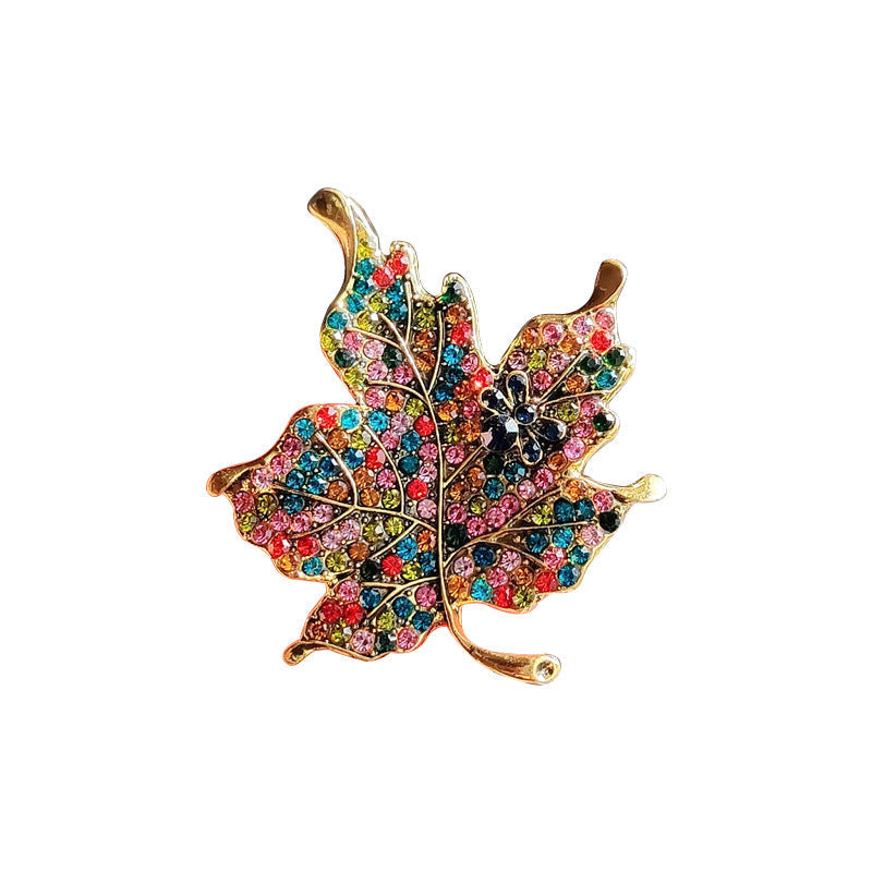 Leaf pin accessory styled with a jacket