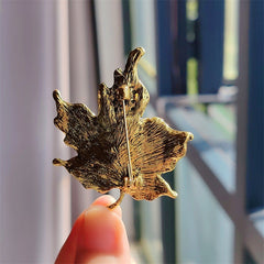 Vintage rhinestone leaf design displayed on fabric
