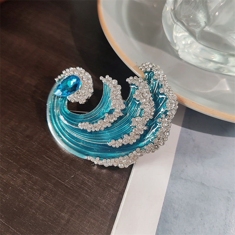 Stylish Waves Brooch against fabric backdrop