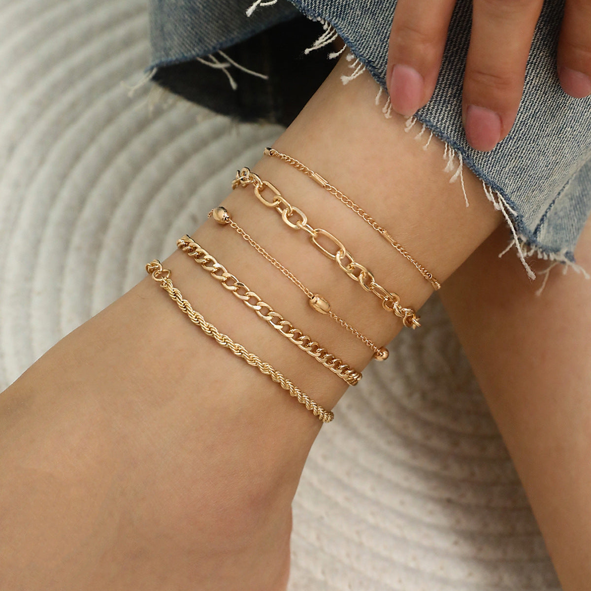 elegant metal anklets stacked
